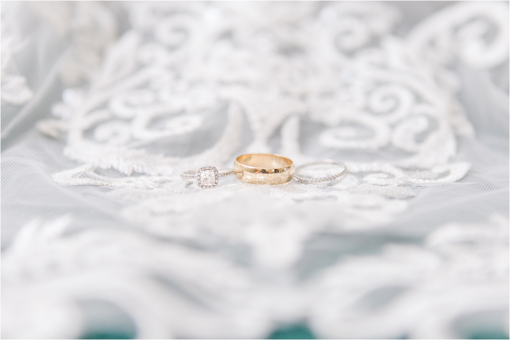 macon wedding bands and engagement ring on lace dress