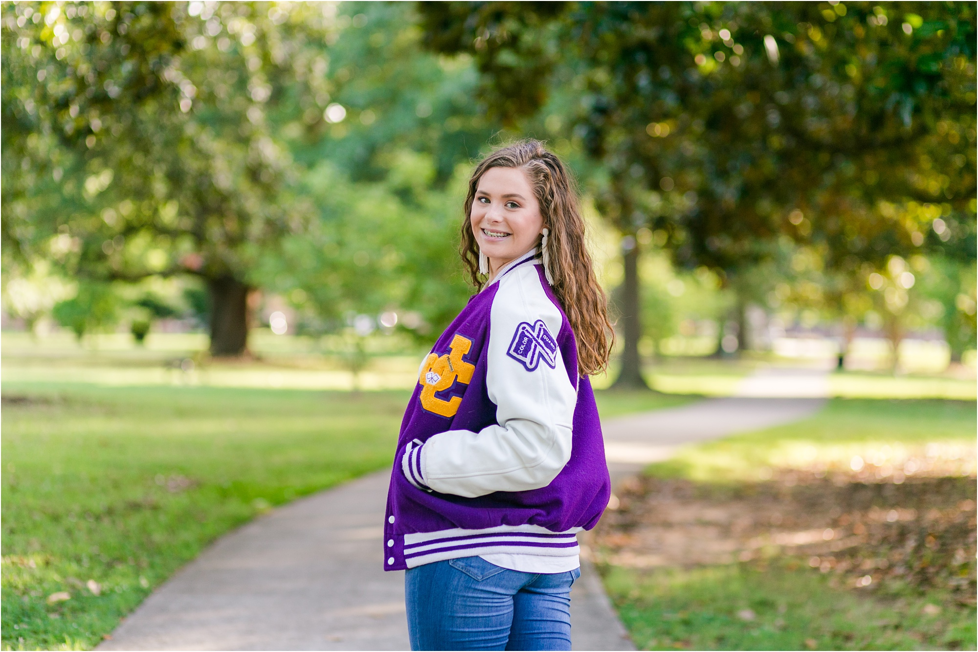 macon georgia class of 2020 senior in yellow shirt and jeans and letterman jacket