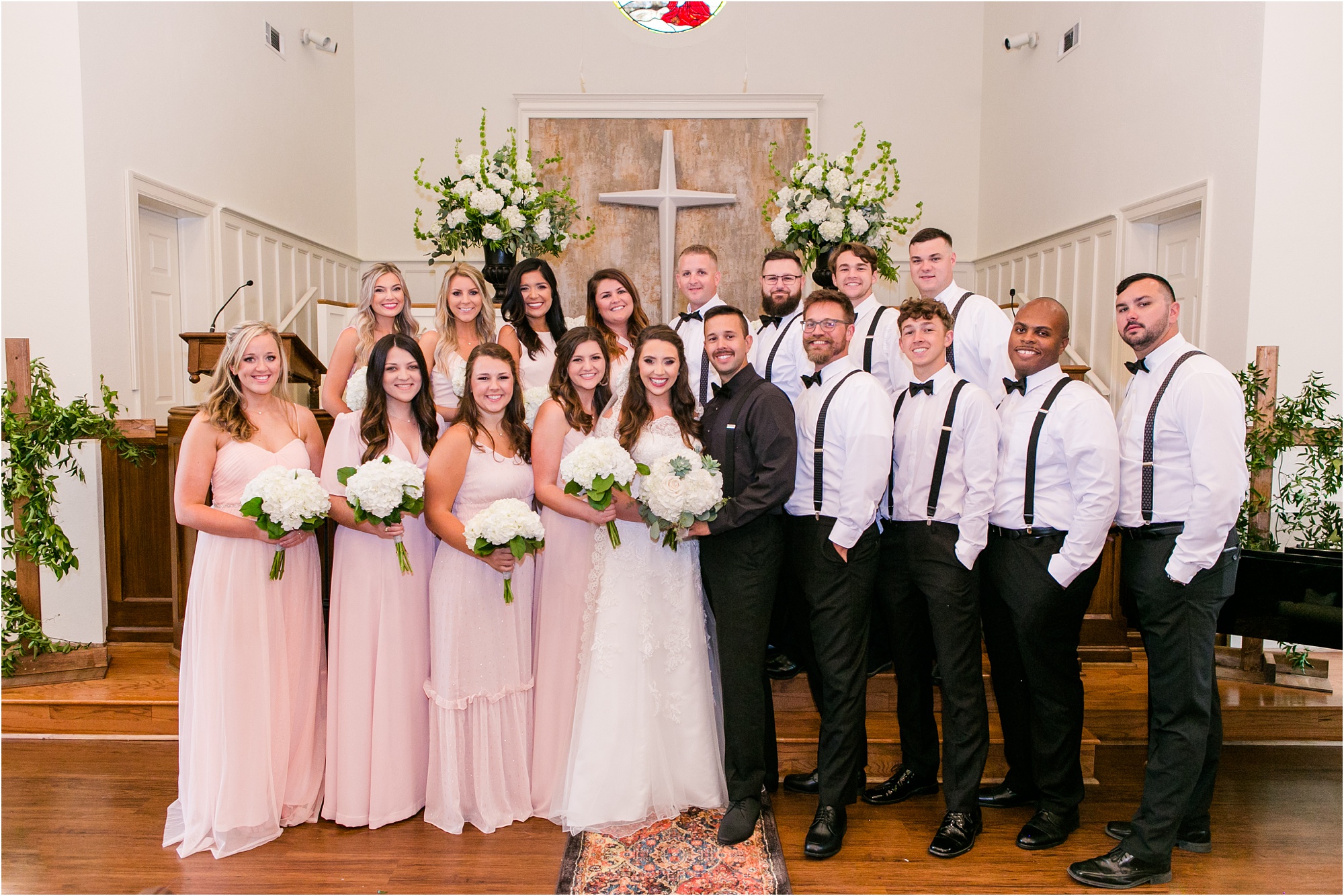 blush, pink, and white bridal party inside of church